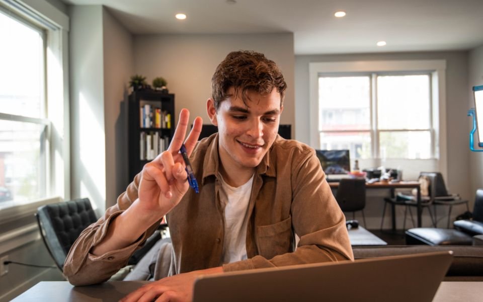 A developer smiling during a video call while working from home