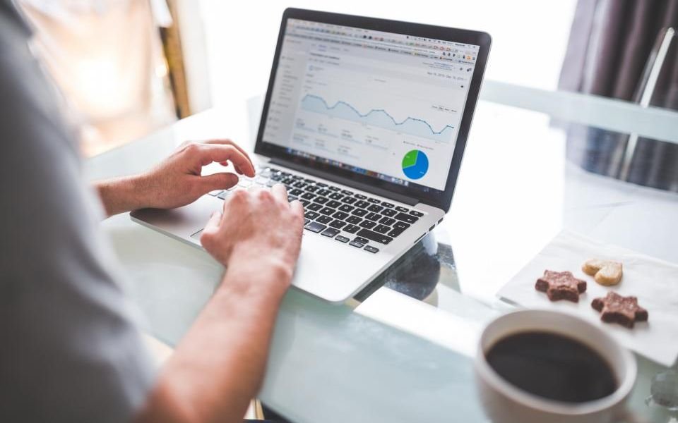 An analyst reviewing charts on a laptop dashboard