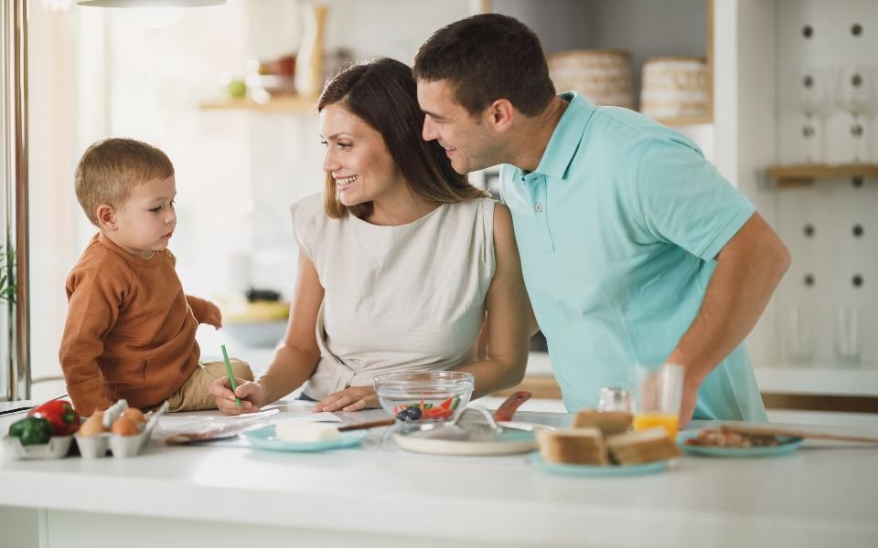 A family together in their kitchen at breakfast