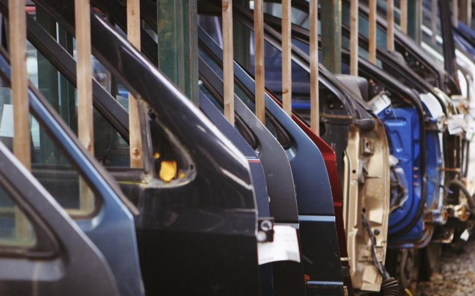 Car doors lined up on a factory production line