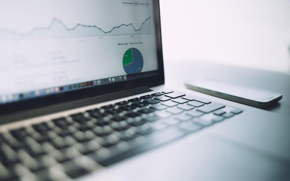 A laptop showing analytics charts, the kind of business data AI in business software works with